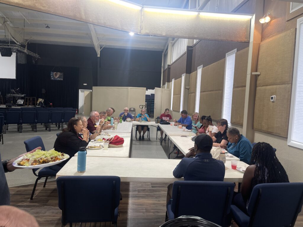 Third Church's IMPACT team and New Vision Ministries group sit and have lunch together