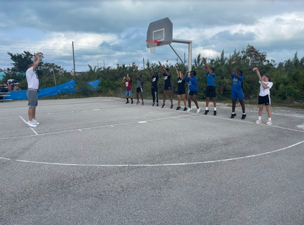 Girls basketball camp learning the proper shooting form