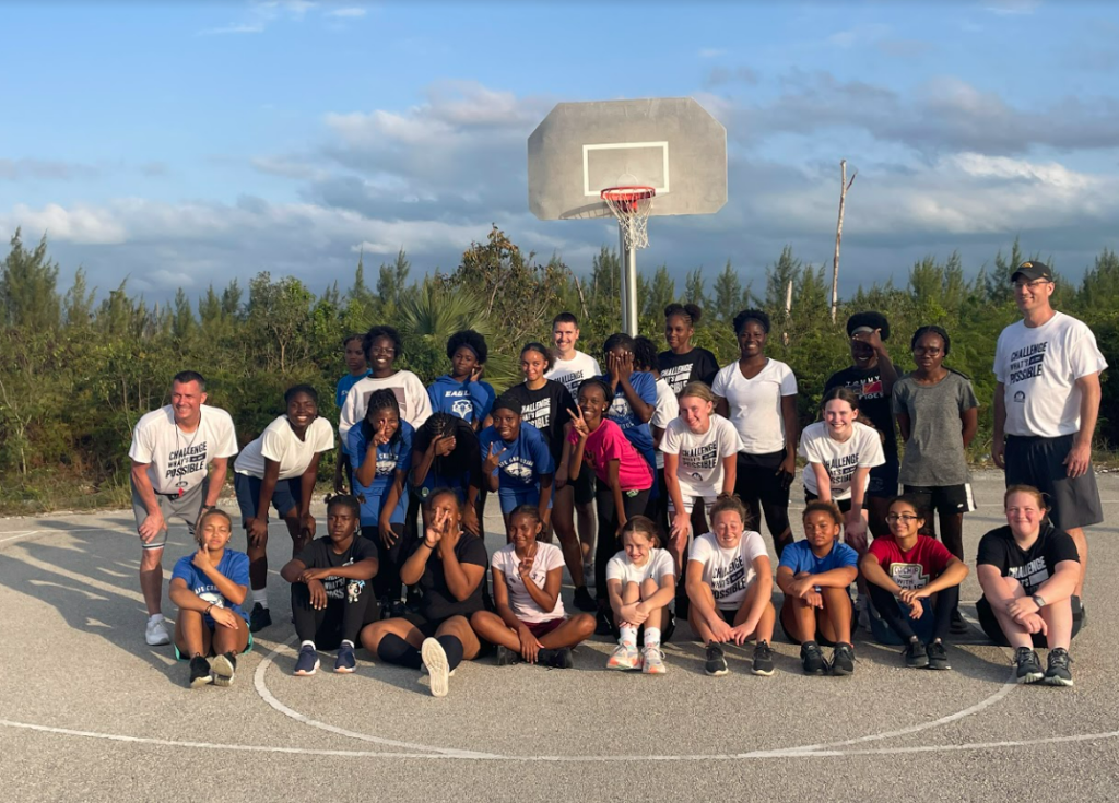 The girl baskeball camp and their three coaches and two assistants.