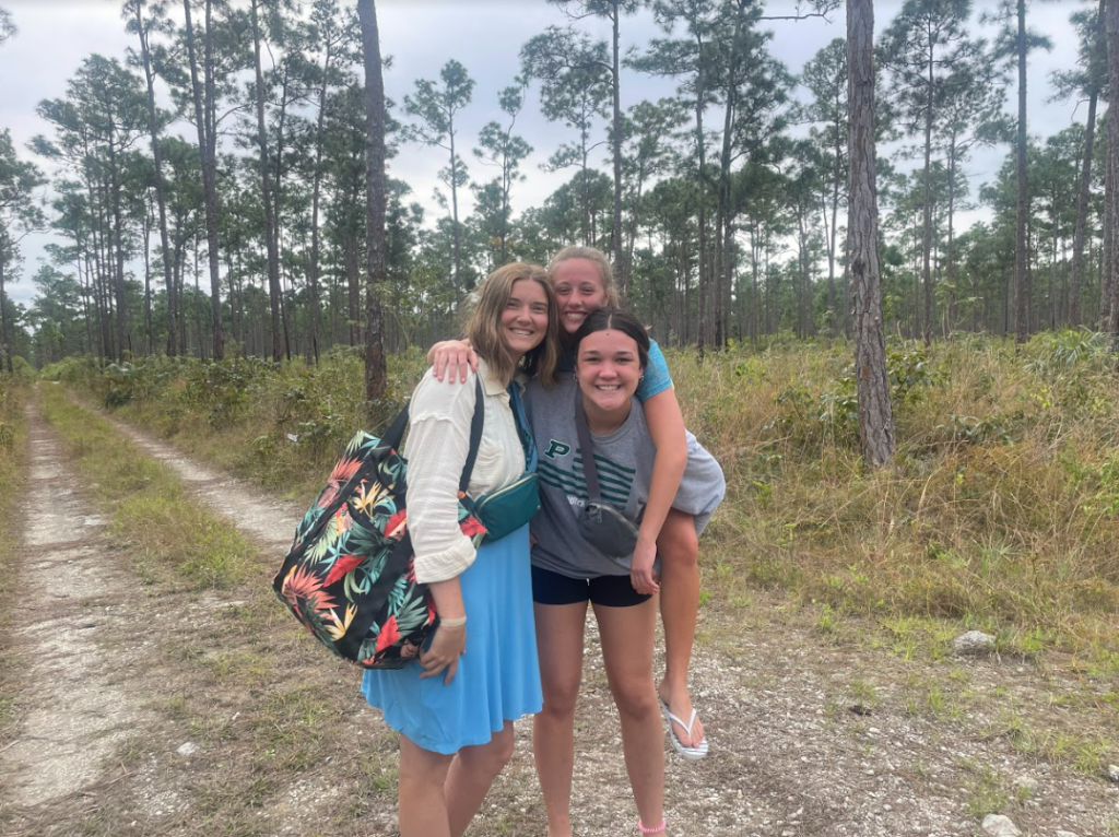 Team members giving piggy back rides and hugging each other