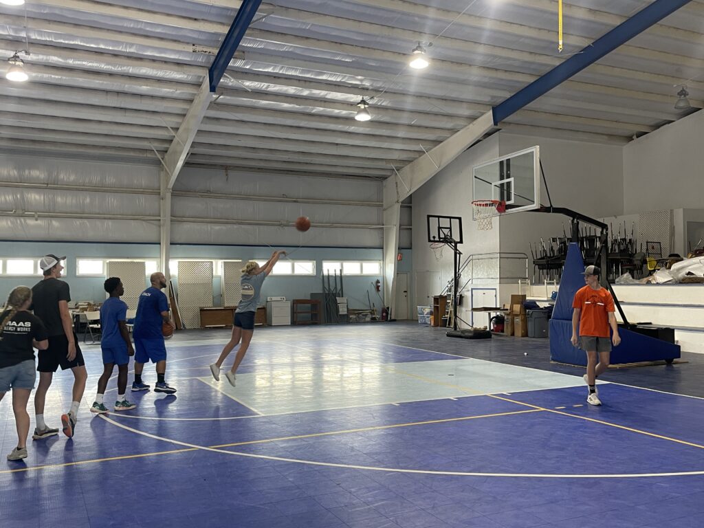 Team members in the Agape gym playing a game of knockout.