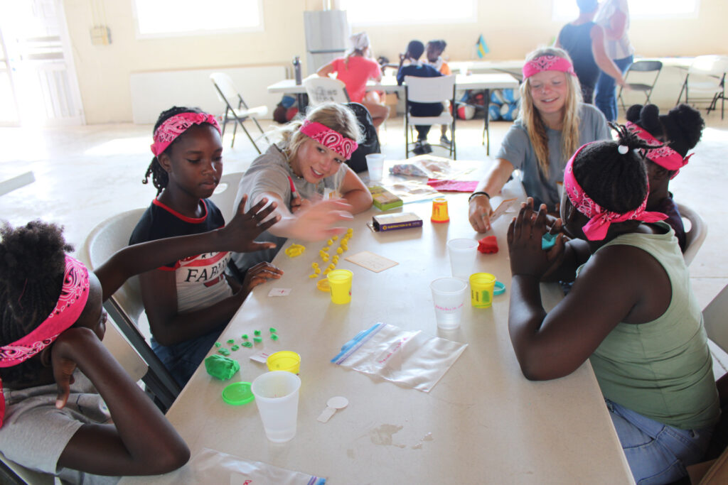 Pink team learns a Play-doh game to work on their math skills.