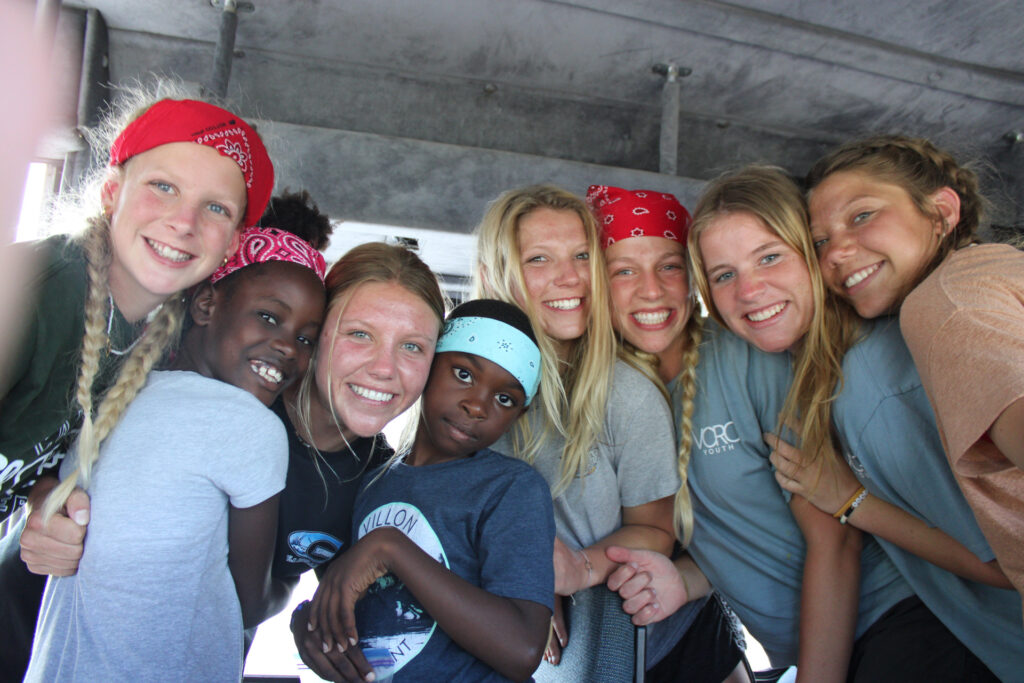 Group picture of the team and two students.