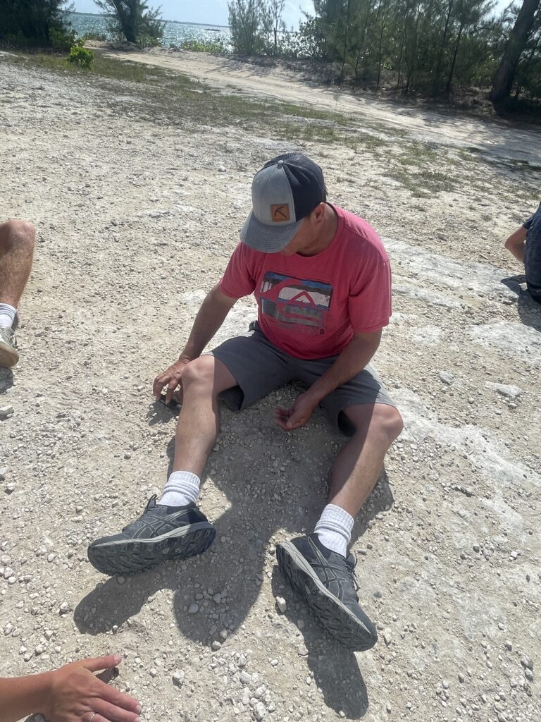 Team sitting on the gravel driveway pickup glass